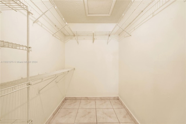 spacious closet featuring light tile patterned floors