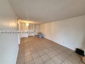 unfurnished living room with light tile patterned floors