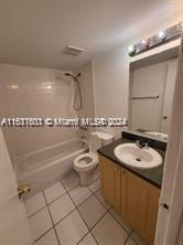 full bathroom featuring vanity, bathtub / shower combination, tile patterned floors, and toilet