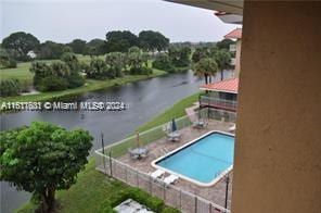 view of swimming pool with a water view