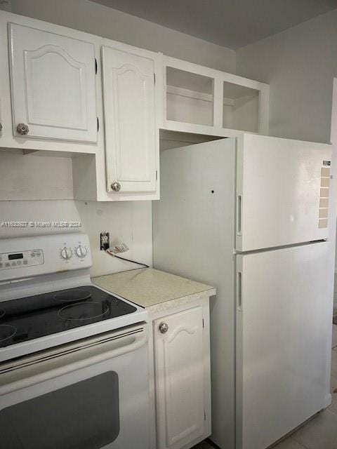 kitchen featuring white cabinetry and white appliances