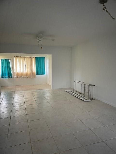 unfurnished room featuring ceiling fan and light tile patterned flooring