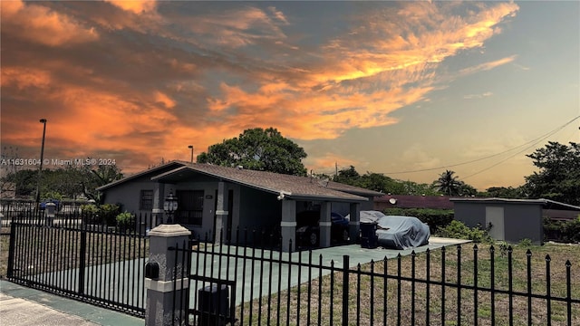 view of front of property with a lawn and a shed