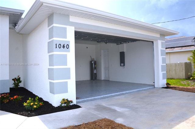 garage with electric water heater and electric panel