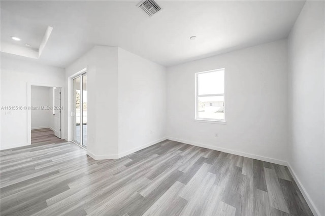 unfurnished room with hardwood / wood-style floors