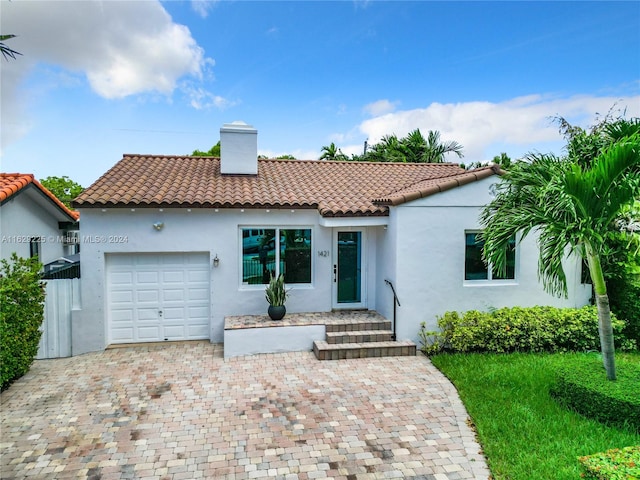 mediterranean / spanish-style home with a garage