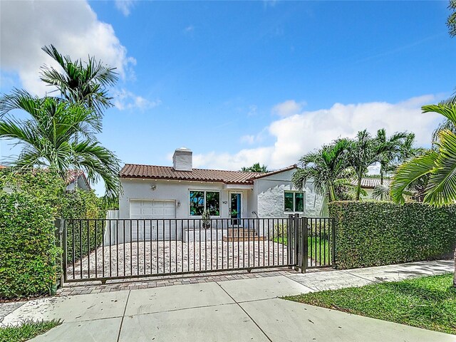 mediterranean / spanish-style house with a garage