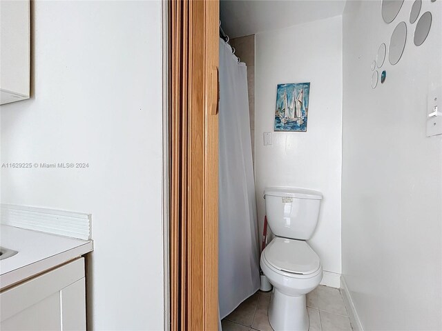 bathroom with vanity, toilet, and tile patterned flooring