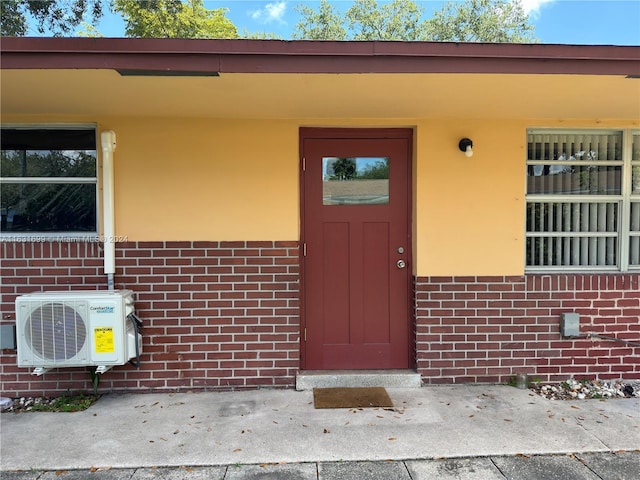 view of exterior entry featuring ac unit