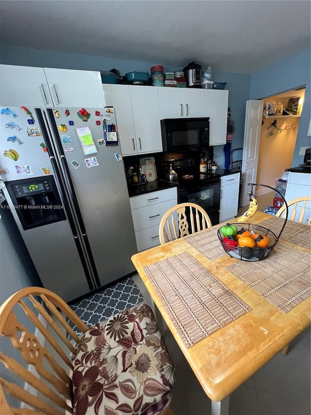 kitchen featuring white cabinetry and black appliances