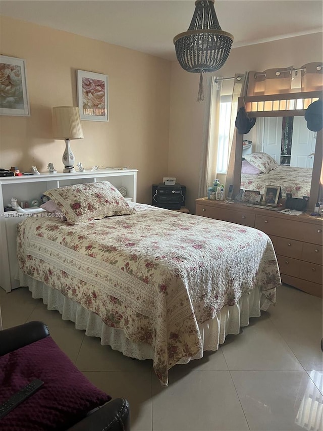 tiled bedroom with a notable chandelier