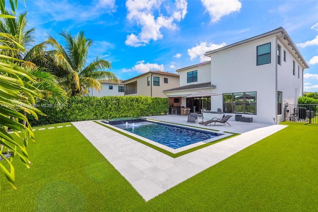 view of swimming pool featuring a patio, a yard, and pool water feature