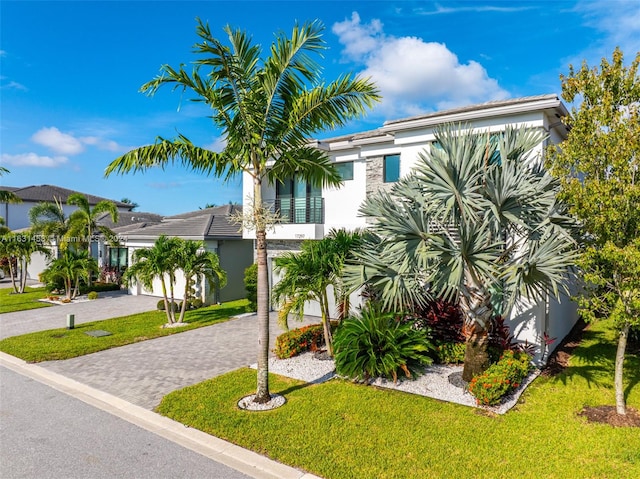 view of front of property featuring a garage and a front yard