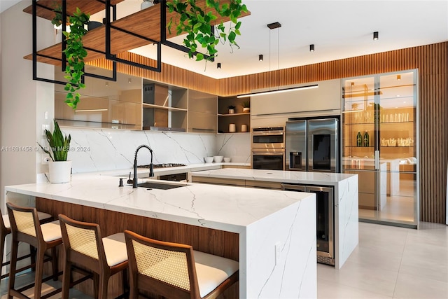 kitchen with appliances with stainless steel finishes, sink, kitchen peninsula, backsplash, and wall chimney exhaust hood