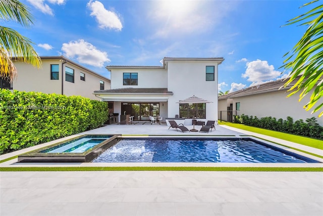 view of pool with an in ground hot tub, a patio, and an outdoor hangout area