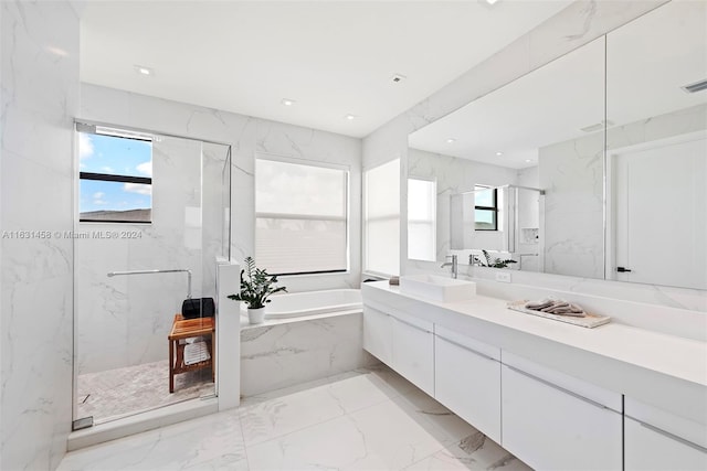 bathroom with dual vanity, tile patterned floors, and separate shower and tub