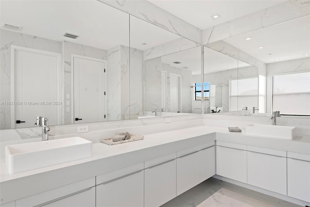 bathroom featuring plenty of natural light, double vanity, tile walls, and tile patterned floors