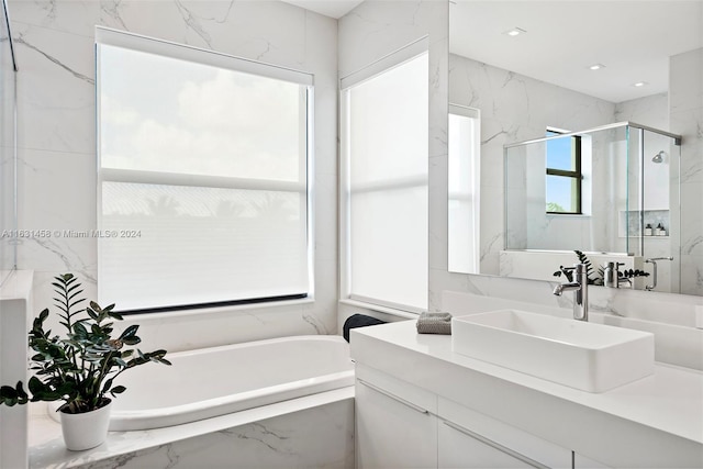 bathroom featuring separate shower and tub and vanity