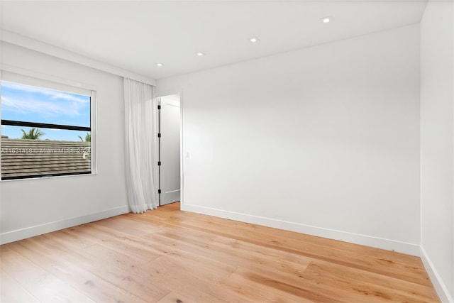 unfurnished room with light wood-type flooring