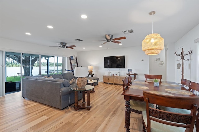 living room featuring light wood-type flooring and ceiling fan