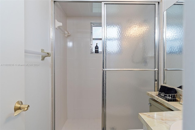 bathroom featuring vanity, toilet, and an enclosed shower