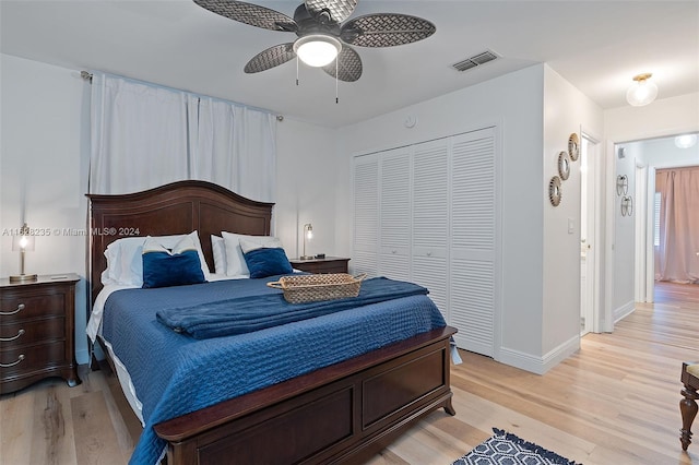 bedroom with ceiling fan, light wood-type flooring, and a closet