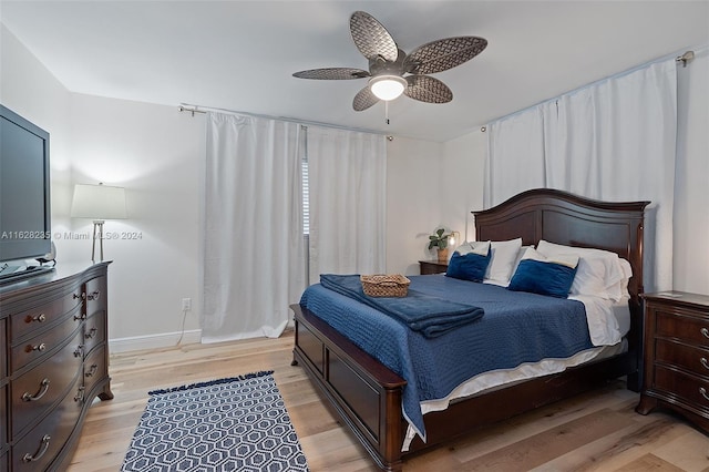 bedroom with ceiling fan and light hardwood / wood-style flooring