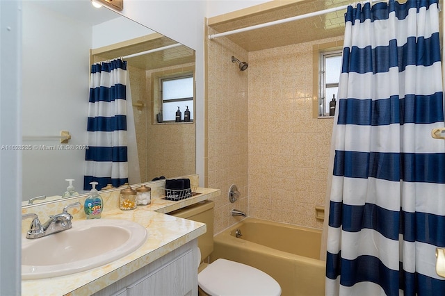 full bathroom with vanity, shower / tub combo, and toilet