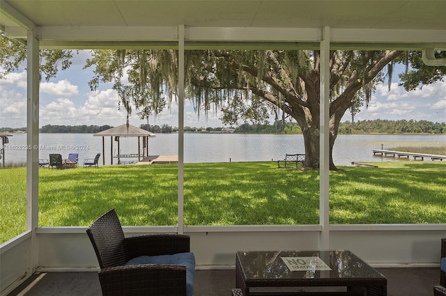 unfurnished sunroom with a water view