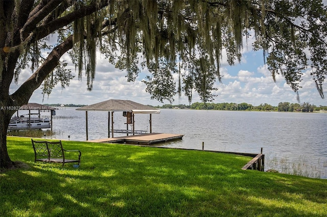 dock area featuring a water view and a lawn