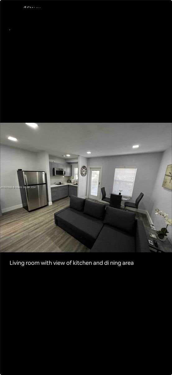 living room with baseboards, dark wood-style flooring, and recessed lighting