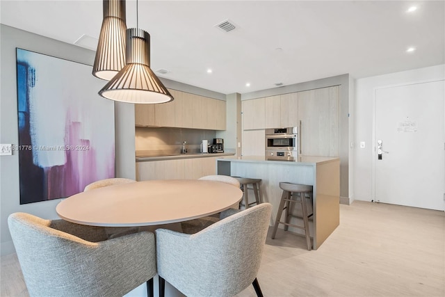 dining area featuring light wood-type flooring