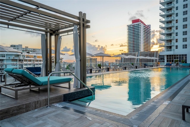 view of pool at dusk