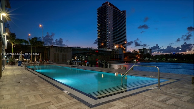 view of pool at dusk