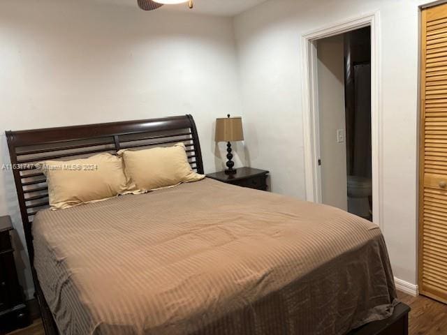 bedroom featuring a closet and dark wood-type flooring