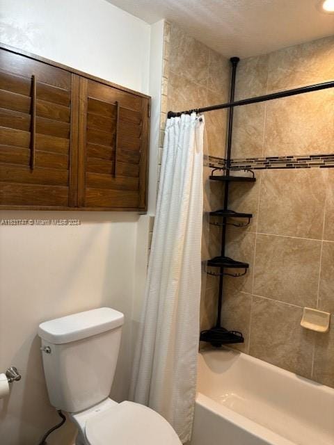 bathroom with shower / bath combination with curtain and toilet