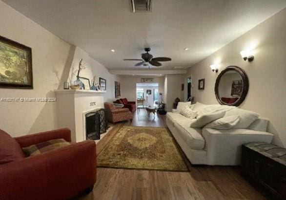 living room with ceiling fan and wood-type flooring