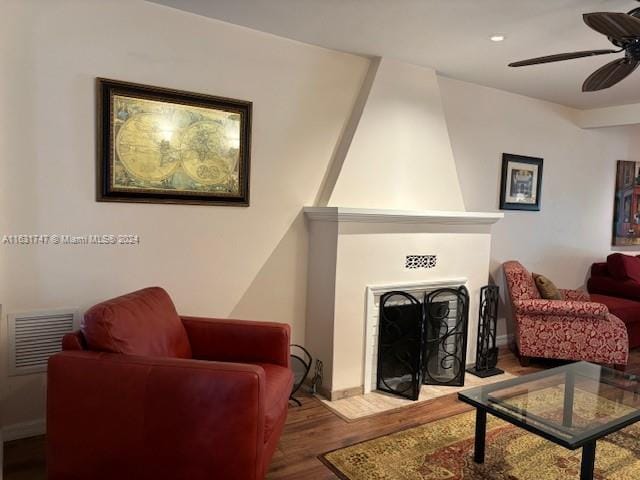 living room featuring ceiling fan and wood-type flooring