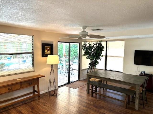 dining space with ceiling fan, a textured ceiling, and hardwood / wood-style floors