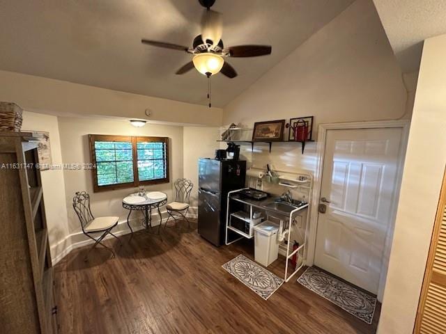 home office with lofted ceiling, dark wood-type flooring, and ceiling fan