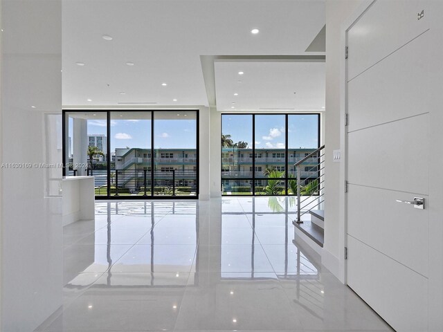 unfurnished room featuring expansive windows