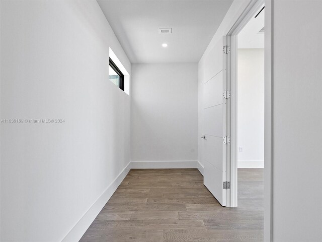 corridor featuring hardwood / wood-style floors