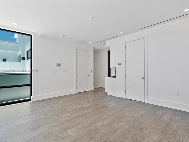 spare room featuring light hardwood / wood-style floors