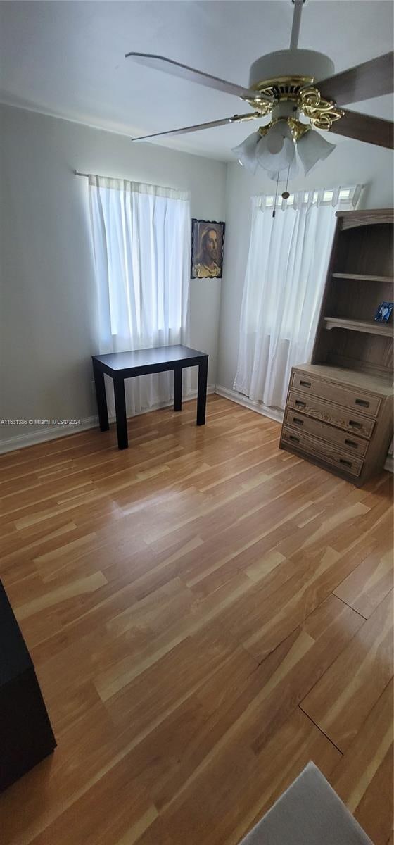 unfurnished room featuring hardwood / wood-style floors and ceiling fan