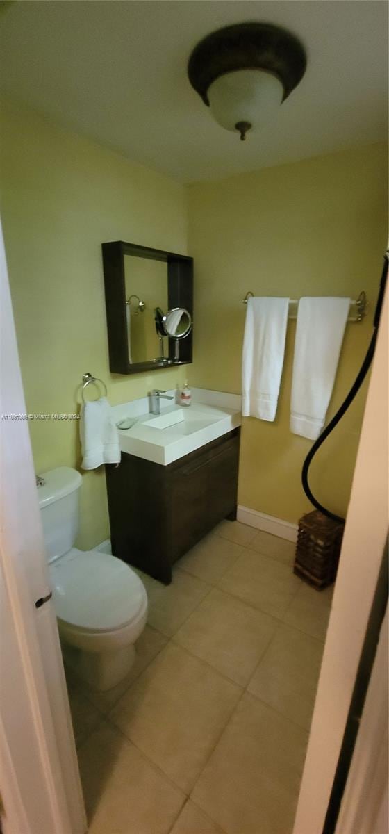 bathroom with tile patterned floors, toilet, and vanity