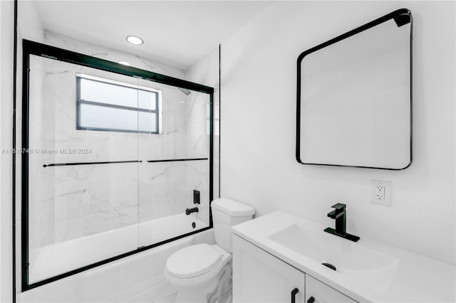 full bathroom featuring vanity, toilet, and enclosed tub / shower combo