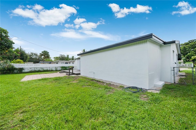 view of home's exterior with a patio area and a yard