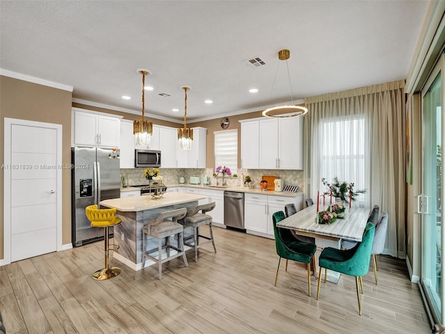 4414 Ficus St, Hollywood, FL 33021 - kitchen featuring light countertops, a sink, a breakfast bar, appliances with stainless steel finishes, and visible vents