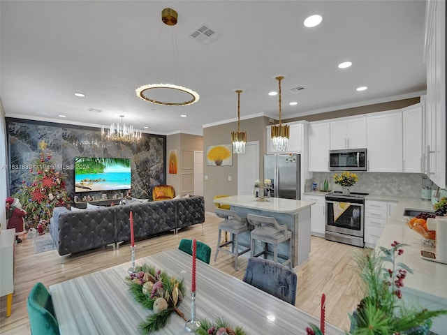 4414 Ficus St, Hollywood, FL 33021 - kitchen with open floor plan, a chandelier, crown molding, and appliances with stainless steel finishes