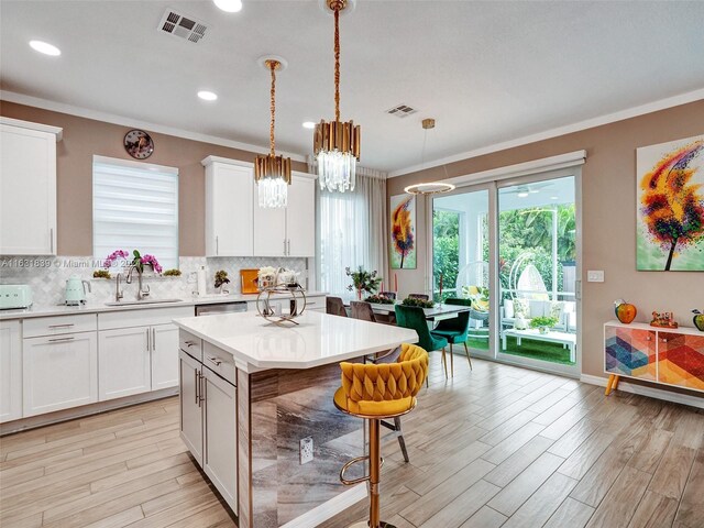 4414 Ficus St, Hollywood, FL 33021 - kitchen with crown molding, backsplash, light countertops, and a sink